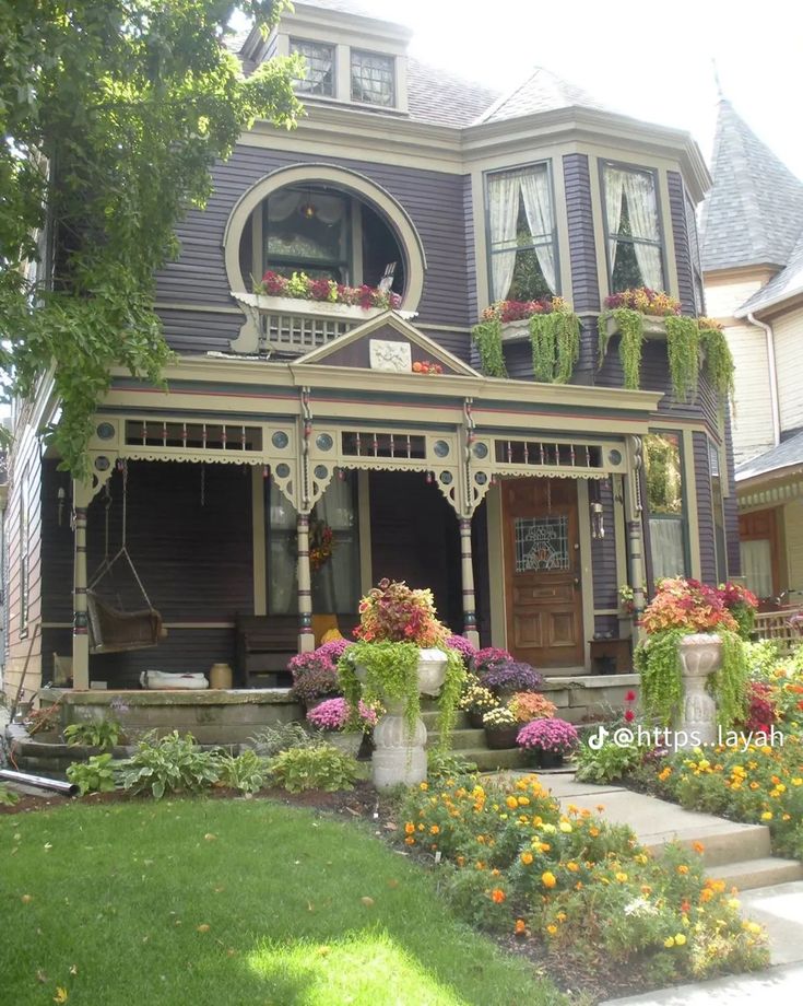 a house with flowers in the front yard