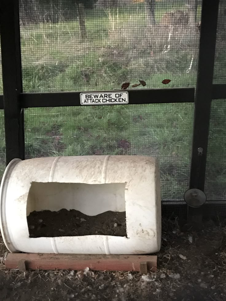 there is a dog house that has been dug up in the ground and dirt inside