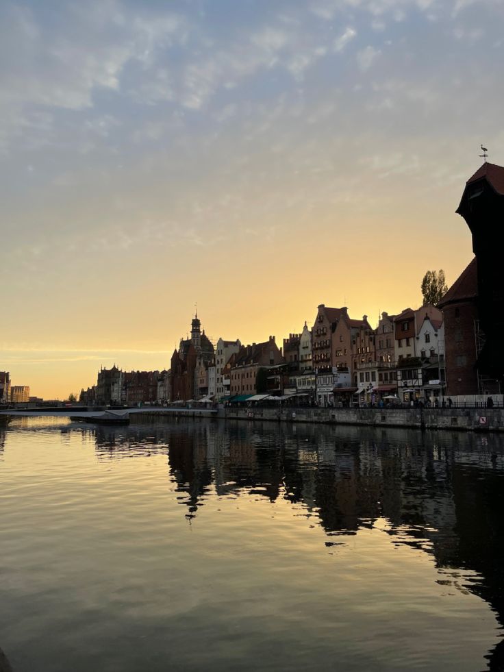 a body of water with buildings in the background