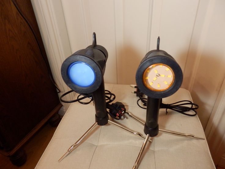 two black lamps sitting on top of a cardboard box