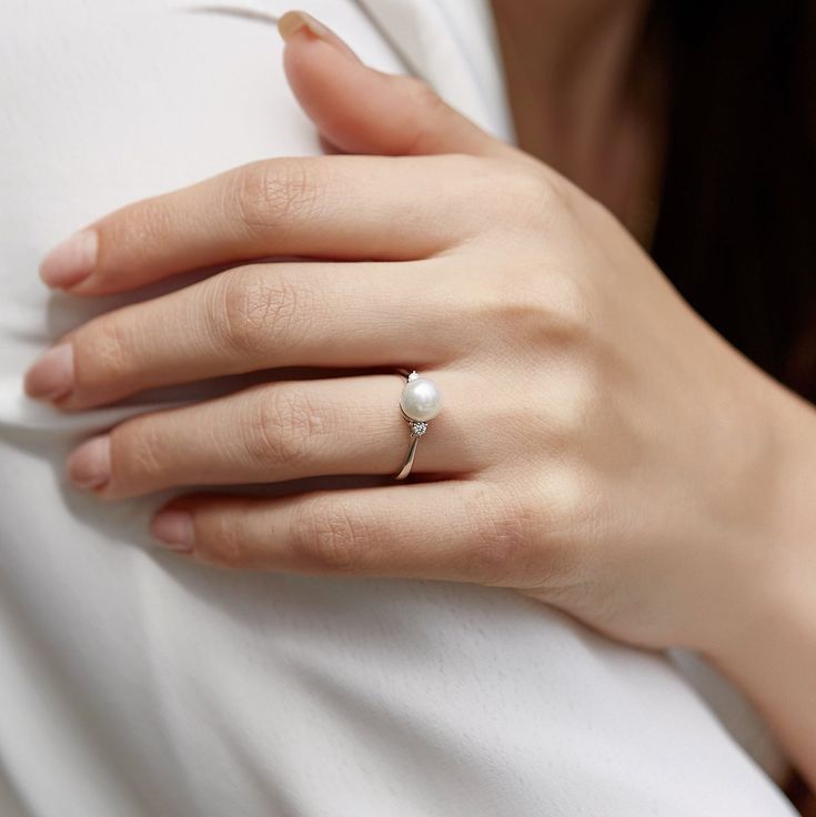 This gorgeous 14K white gold pearl ring is mounted with a beautiful 7.5-8mm AA+ quality Japanese Akoya pearl with 'Very High' luster (please see our Akoya pearl grading section for more information). This beautiful pearl ring includes .08 carats of SI-quality diamonds and is made of 1.77 grams of the highest quality 14K gold. All pearl rings are approved by our staff of GIA pearl experts and come packaged in a beautiful pearl jewelry box. Please view the options below to customize your pearl rin White Gold Akoya Pearl Ring, White Solitaire Pearl Ring Fine Jewelry, White Gold Akoya Pearl Ring With Round Cut, Minimalist Pearl Ring For Formal Occasions, Akoya Pearl White Pearl Ring In Fine Jewelry Style, Akoya Pearl White Pearl Ring Fine Jewelry, Classic Diamond Pearl Ring In Pearl White, Classic Diamond Pearl Ring In White, White Gold Solitaire Pearl Ring