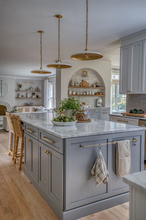 a large kitchen with an island in the middle