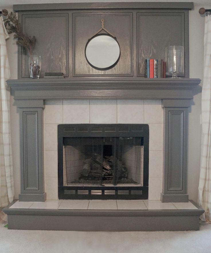 a fireplace with a mirror above it in a living room