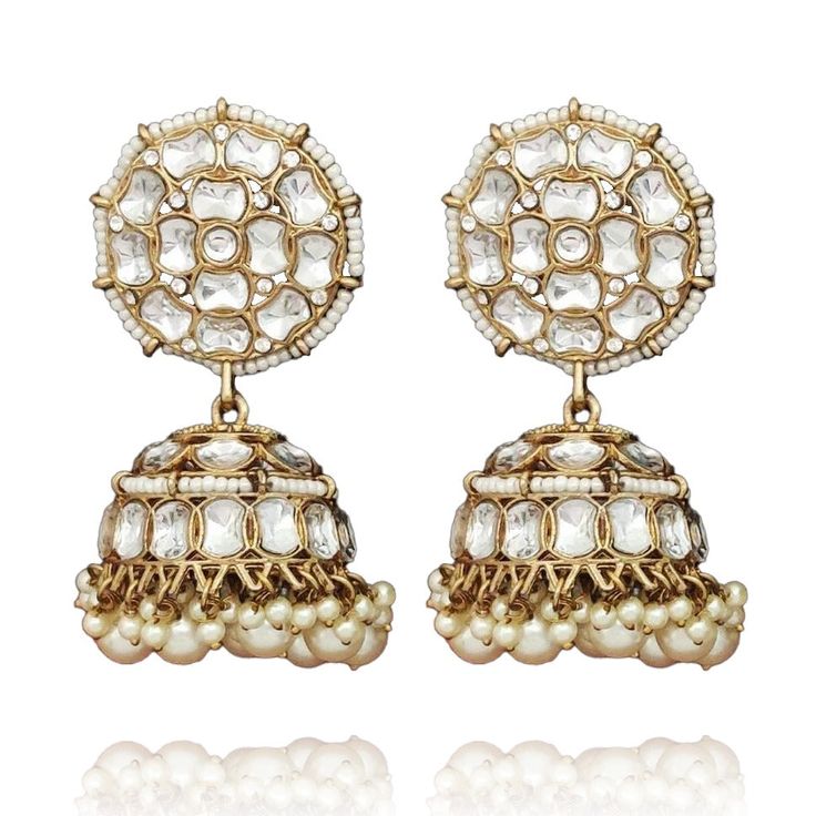 A must-have to create gorgeous everyday looks! Jhumki earrings ornamented with kundan stones and pearls. Approximate earrings length is 2.9" and width is 1.2". Antique gold-plated on high-quality brass as the base metal. In-stock & ready-to-ship. *Please Note: We use faux stones and beads in all of our jewelry. Kundan Jhumkas With Gota Work For Reception, Temple Jewelry Style Brass Cutdana Earrings, Temple Jewelry Style Brass Earrings With Cutdana, Brass Cutdana Temple Jewelry Earrings, Festival Brass Earrings With Cutdana, Kundan Earrings With Stone Work For Reception, Festive Gold-plated Stone Work Jhumkas, Festive Gold-plated Jhumkas With Stone Work, Brass Bridal Earrings For Wedding