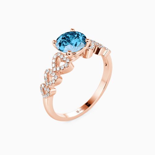 a rose gold engagement ring with an oval blue topazte and diamonds on the side