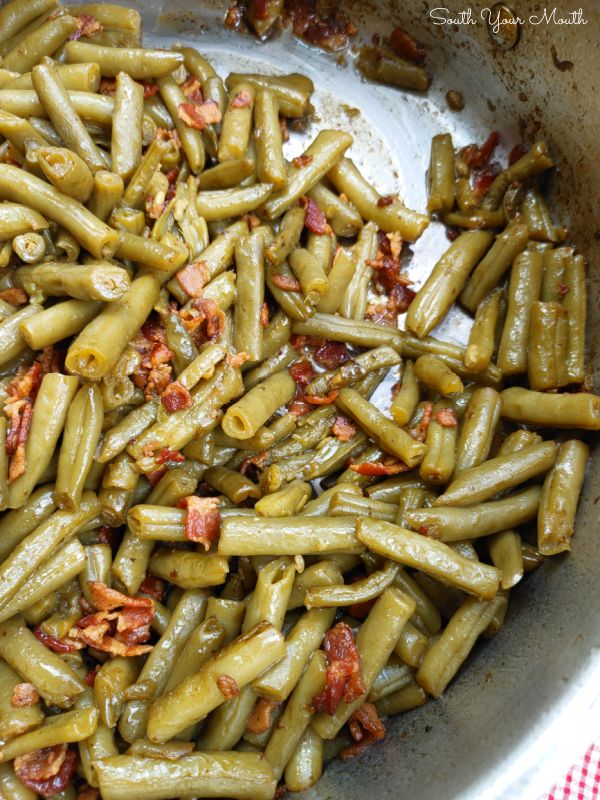 green beans in a pan with bacon on top and the words southern - style canned green beans