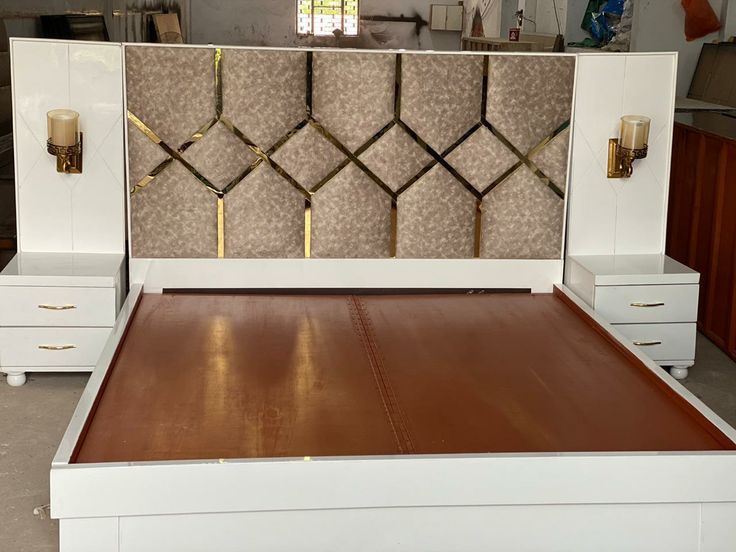 the bed is made up and ready to be used as a headboard or night stand