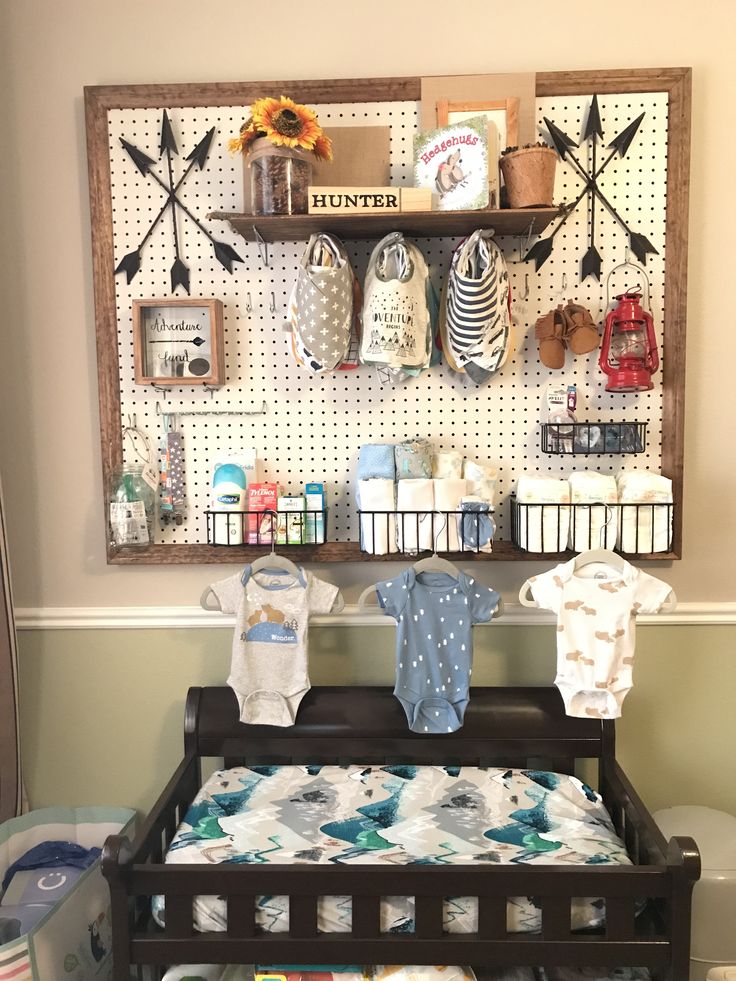 a baby's room with an ironing board on the wall