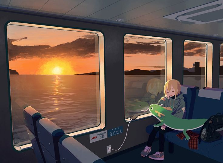 a person sitting on a train looking out the window at the ocean and setting sun