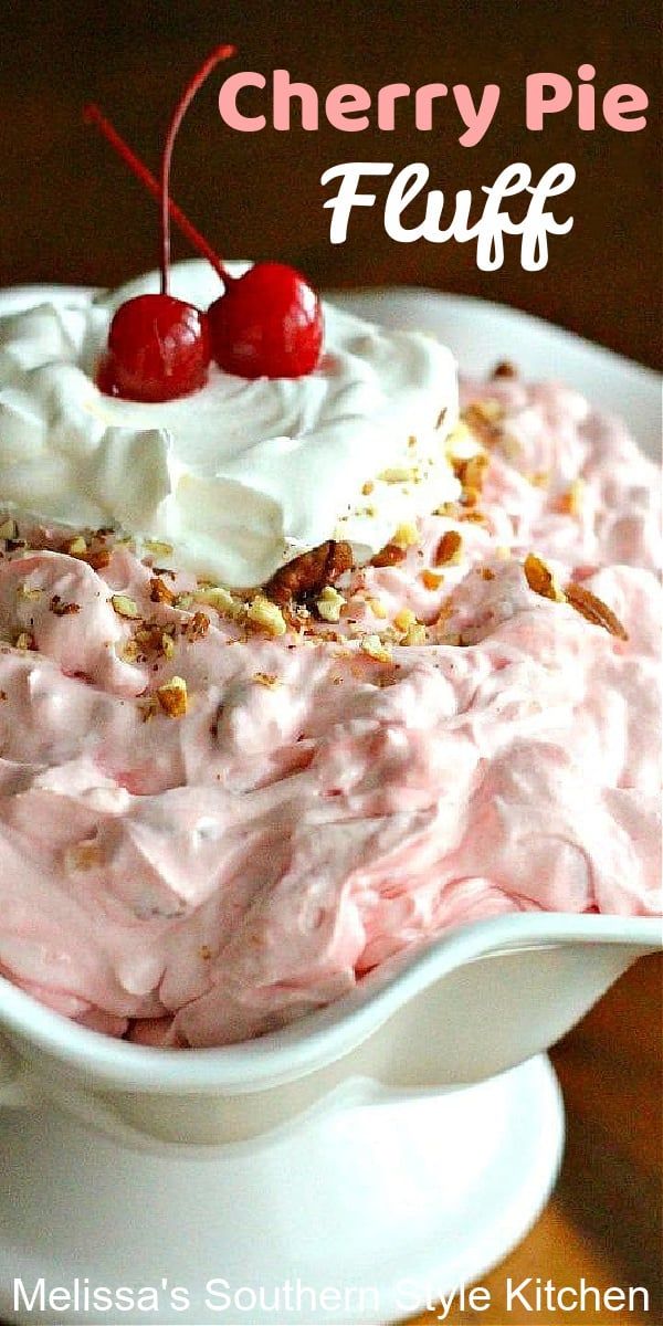 a close up of a cake with cherries on top and the words cherry pie fluff above it