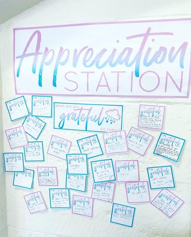 a white wall with blue and pink writing on it that says appreciation station