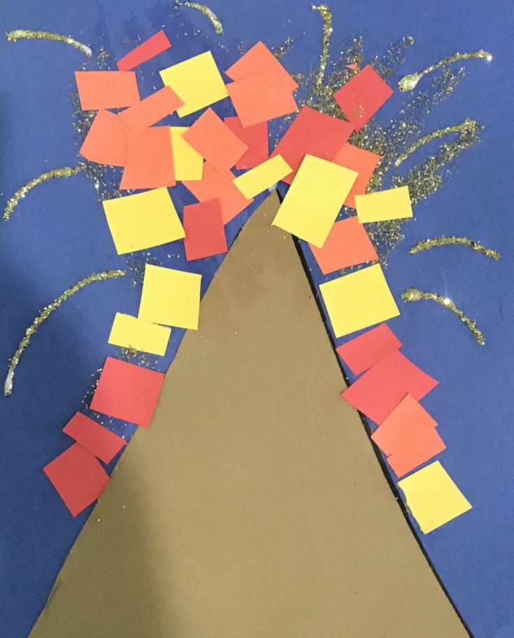 a piece of paper that has been cut out to look like a volcano with yellow and red squares on it