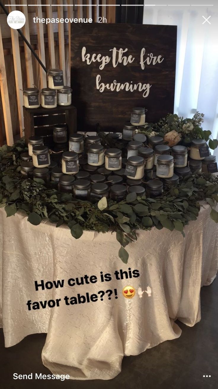 a table topped with lots of candles next to a sign