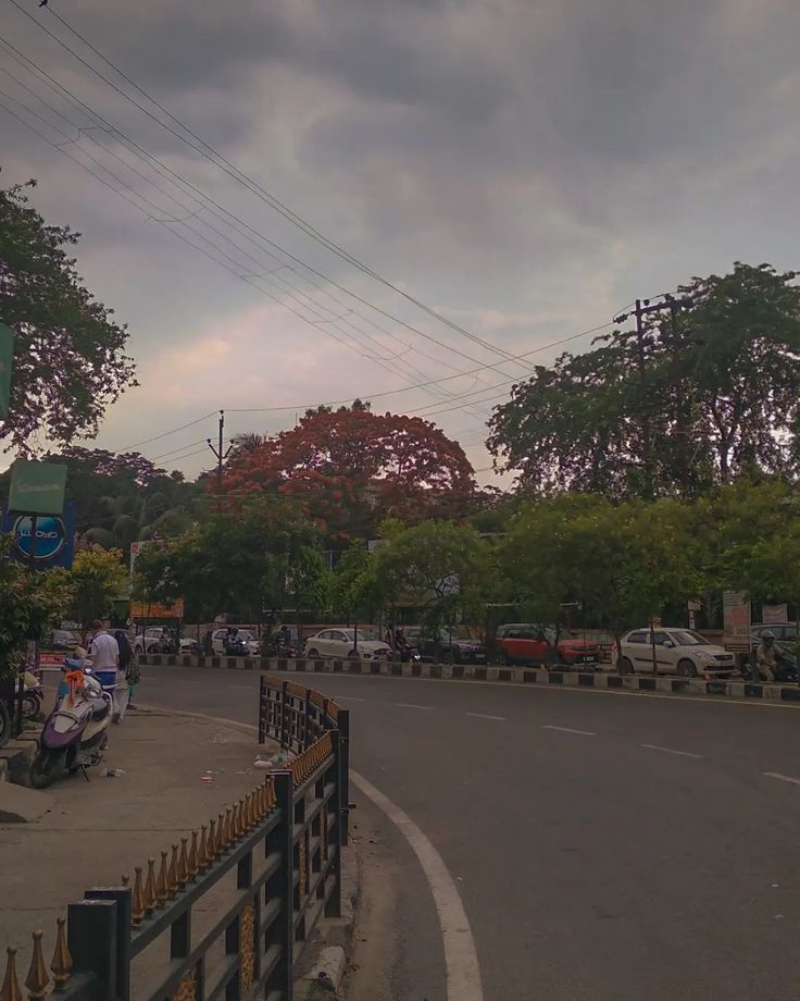 an empty street with cars and motorcycles on it