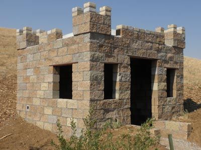 an old brick building sitting on top of a hill