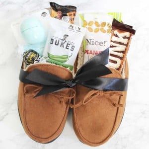 a pair of brown slippers sitting on top of a white counter next to candy