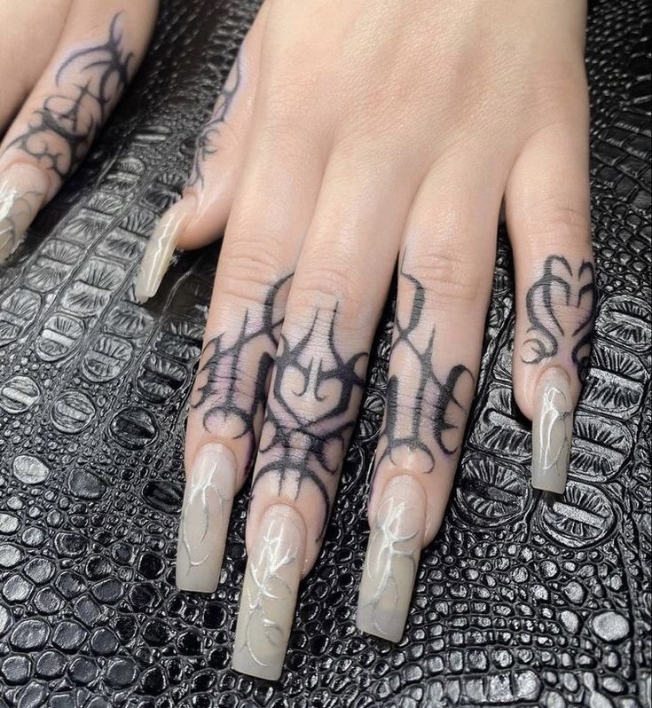 a woman's hand with tattoos on it