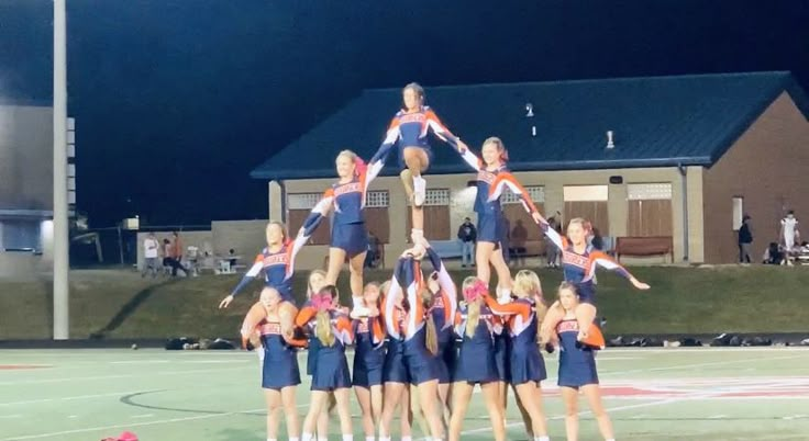 a group of cheerleaders standing on top of each other