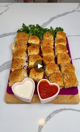 a platter filled with sandwiches and dipping sauces