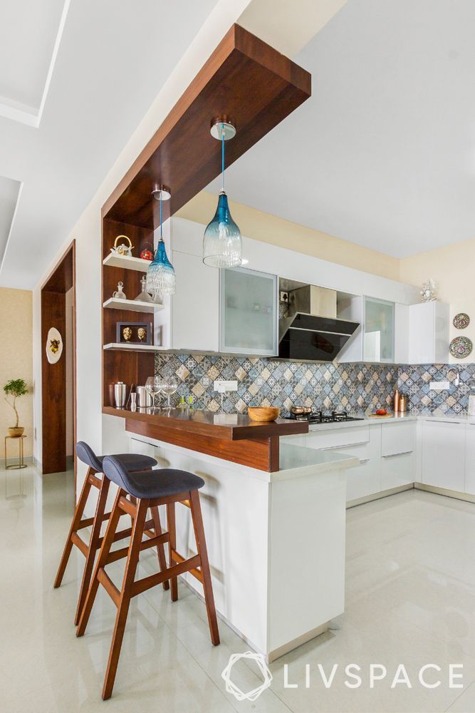 a kitchen with two bar stools next to an island