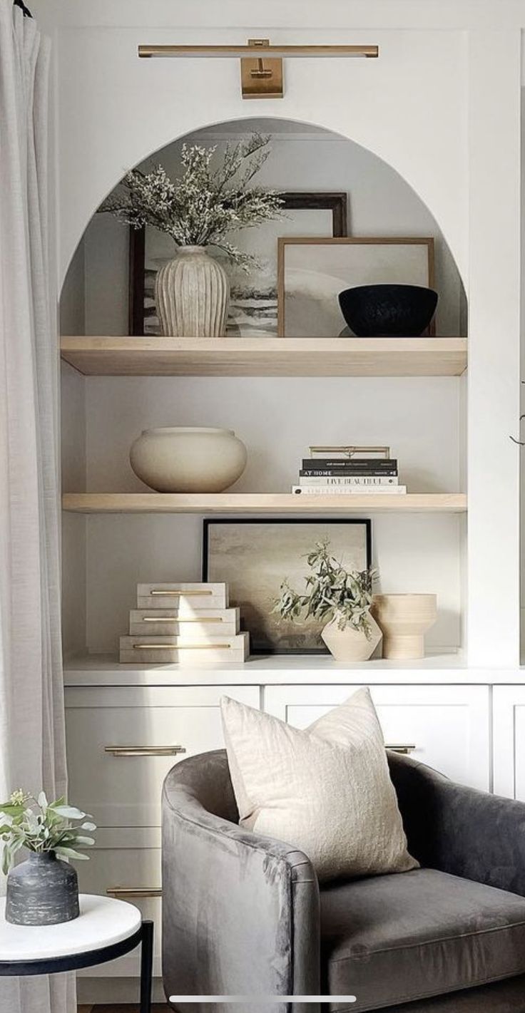 a living room filled with furniture and shelves