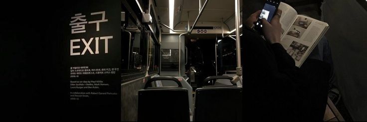 a person sitting on a bus reading a book and holding a cell phone in their hand