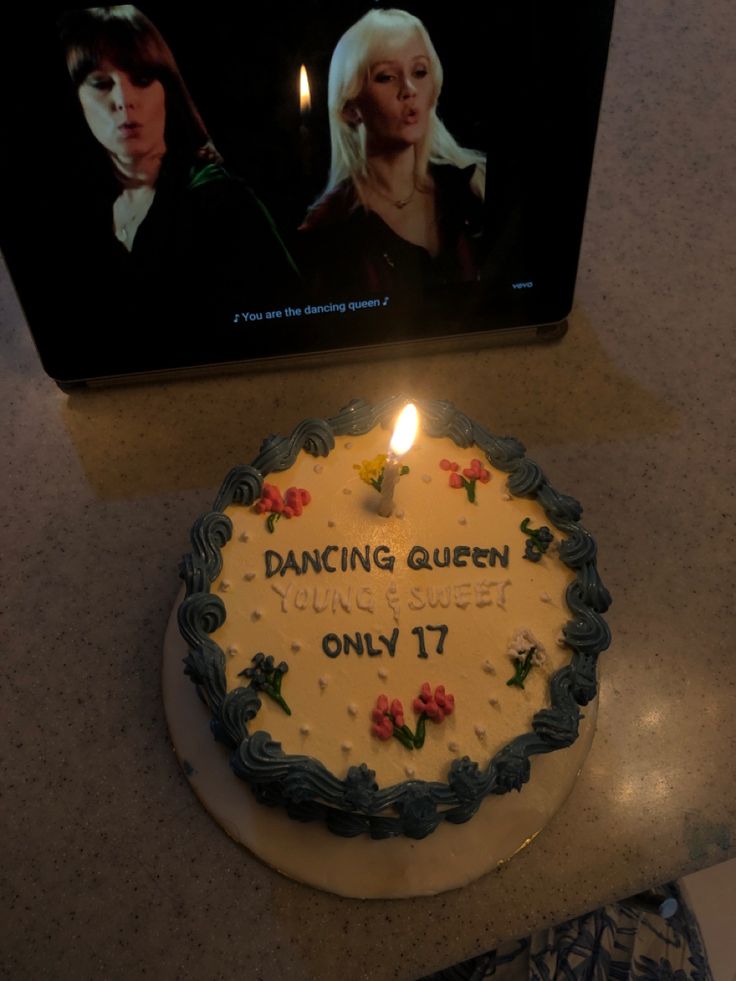 there is a cake with candles on it that says dancing queen young and sweet only 17