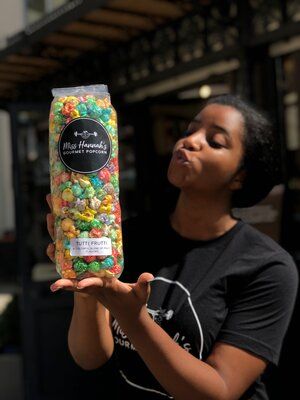 a woman holding up a bag of gummy bears