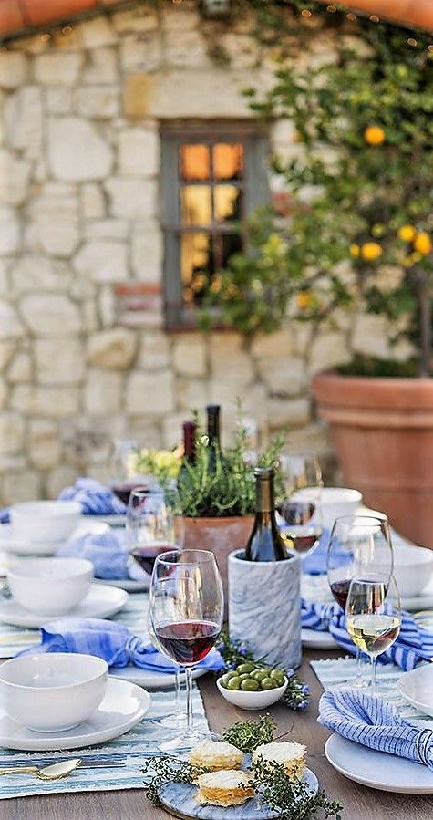 the table is set with wine, cheese and bread for two people to eat together