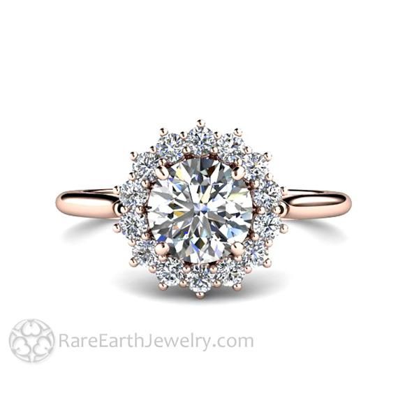 an engagement ring with a halo setting and round diamonds on the band, set in 18k rose gold