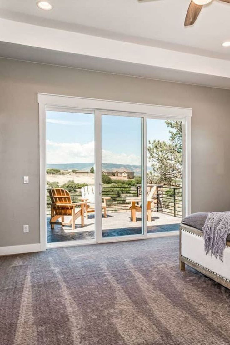 a large bedroom with sliding glass doors leading outside