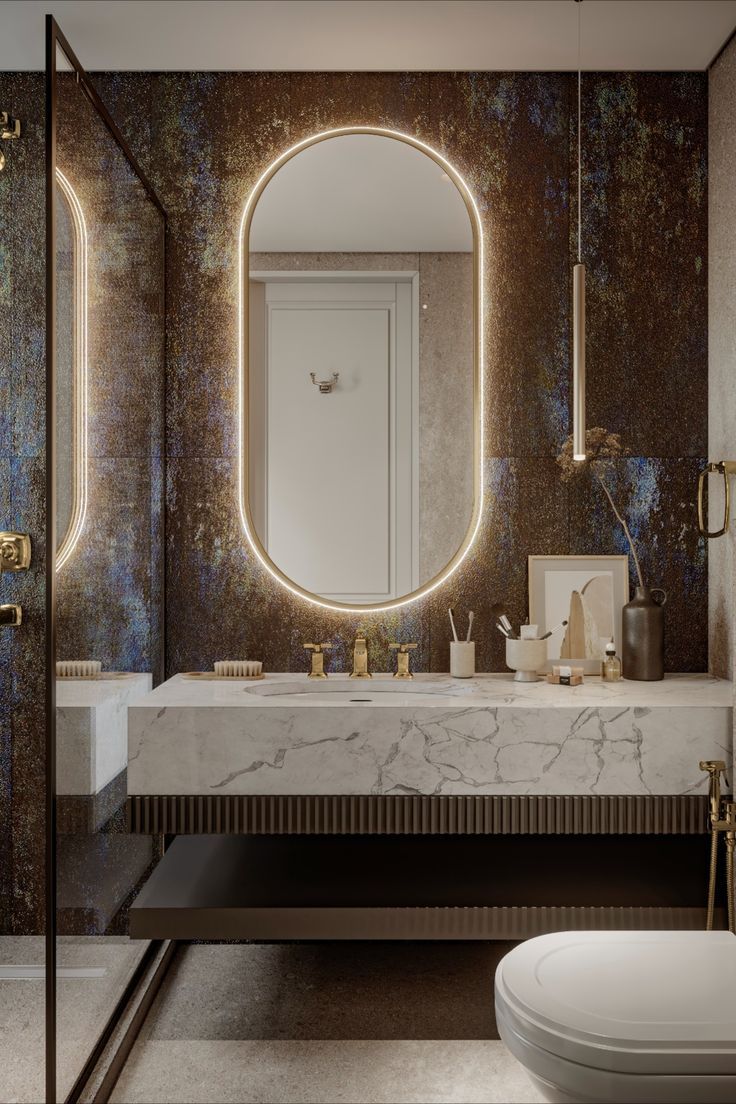 a bathroom with marble counter top and round mirror