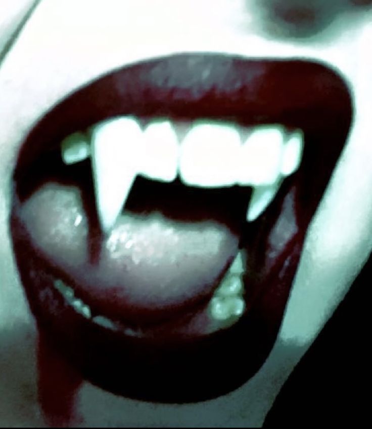 a woman's mouth with white teeth and blood on it