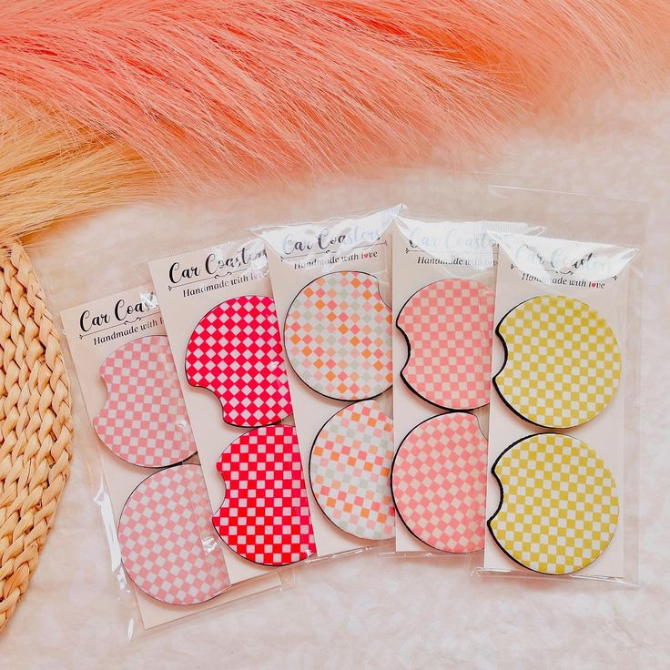 four pieces of heart shaped paper on top of a white table next to a basket