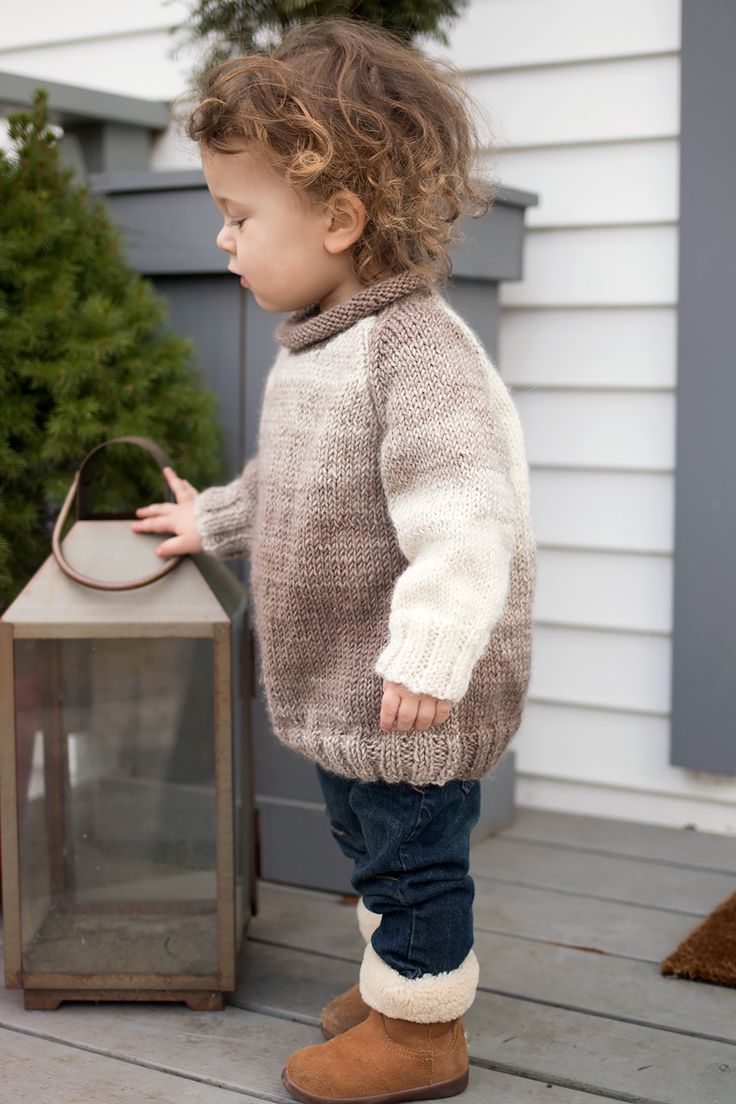 a small child standing next to a lantern