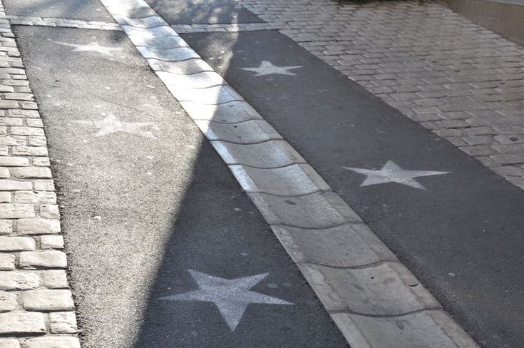 the sidewalk has stars painted on it