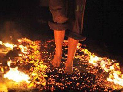 a person standing on top of a pile of fire