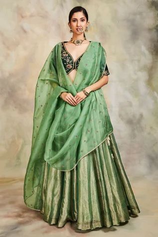 Green lehenga with all-over gold zari work. Comes with embroidered blouse and dupatta.
Component: 3
Embroidery
Neckline: V neck
Sleeve Length: Half
Fabric: Tissue, Raw Silk and Organza
Color: Green
Embroidered dupatta with lace trim edge
Side tie up with tassels
Closure: Hook front - Aza Fashions Raw Silk Lehenga, Organza Lehenga, Anamika Khanna, Lehenga Designs Simple, Diana Penty, Green Lehenga, Half Saree Designs, Embroidered Lehenga, Sonakshi Sinha