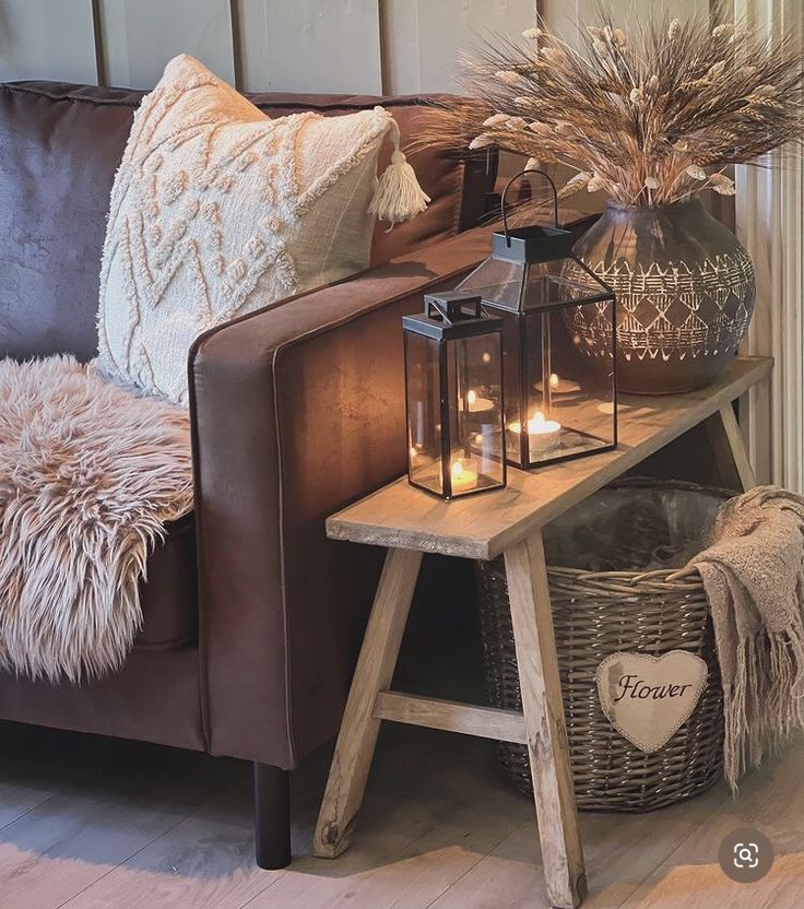 a living room with a couch, table and candles