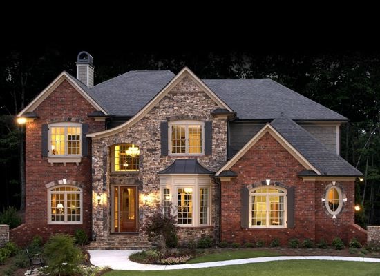 a large brick house lit up at night