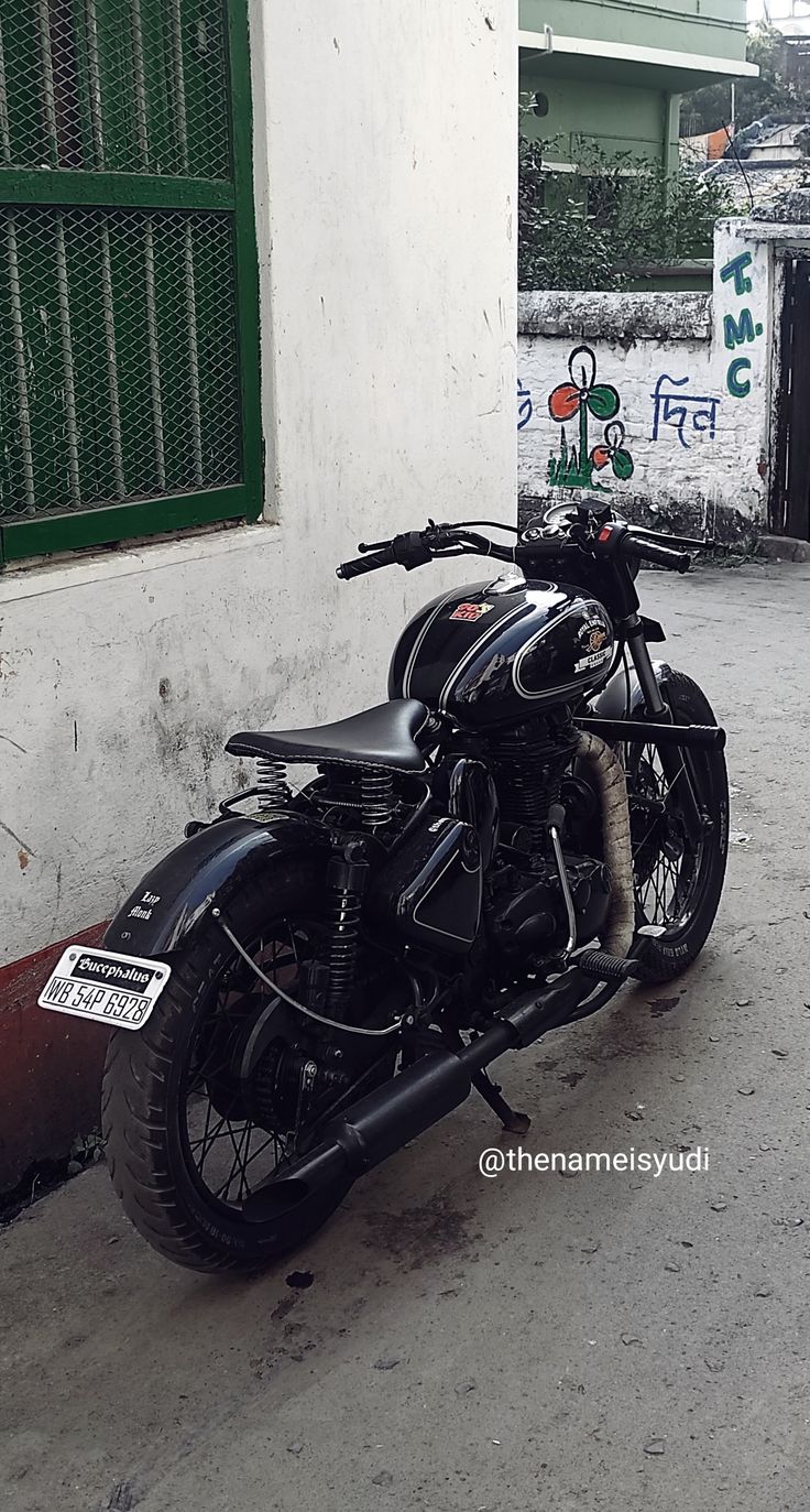 a black motorcycle parked in front of a building