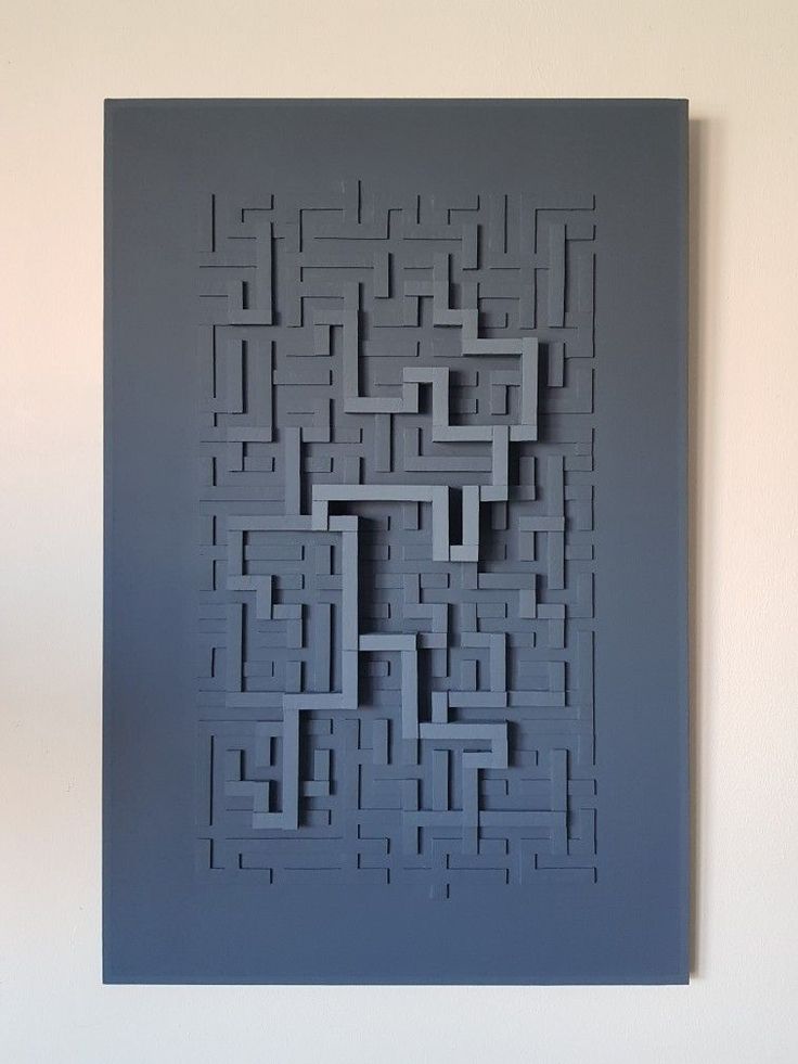 a piece of art that looks like a maze on the wall with no one in it