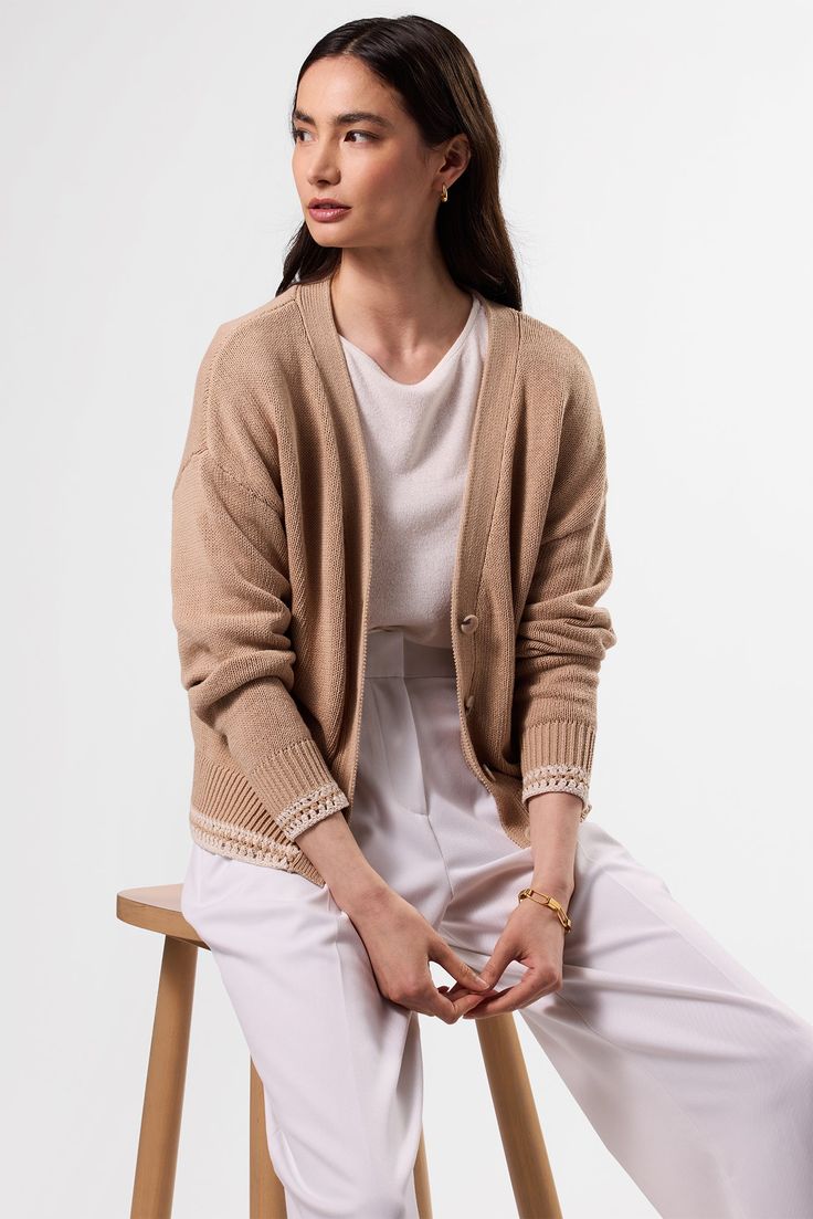 Airy, effortless, and endlessly versatile this it the lightweight cardigan you'll reach for time and again.Long-sleeved, v-neck, drop shoulder cardigan with contrasting crochet trimUrea buttons100% Organic Cotton20 3/4" in LengthEthically Made in ChinaPart of a Matching Set Cream Cashmere V-neck Cardigan, Elegant Beige Cashmere V-neck Sweater, Elegant Cashmere V-neck Cardigan, Soft Knit V-neck Cardigan For Daywear, Beige Knit V-neck Cardigan, Elegant Cream V-neck Cardigan, Elegant V-neck Fine Knit Cardigan, Neutral V-neck Cardigan For Work, Elegant V-neck Cashmere Cardigan