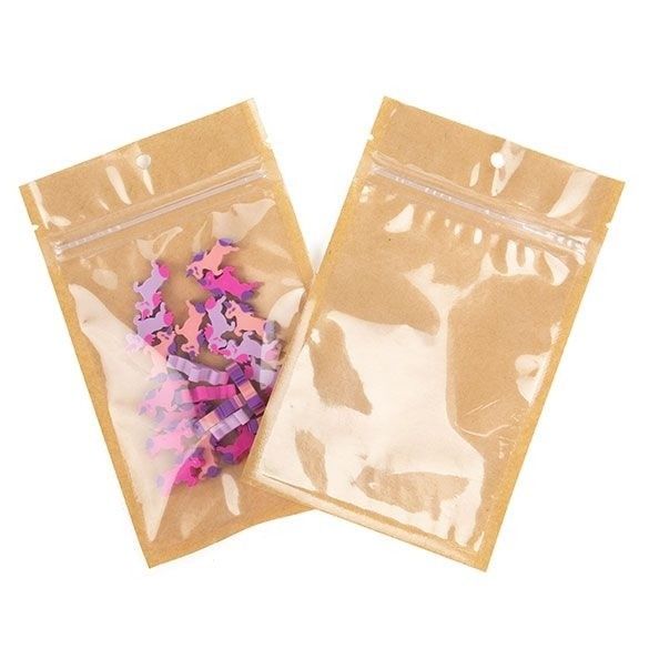 two bags filled with pink and purple confetti on top of a white surface