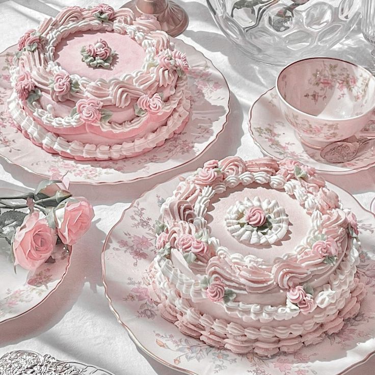 a table topped with pink and white plates covered in frosting