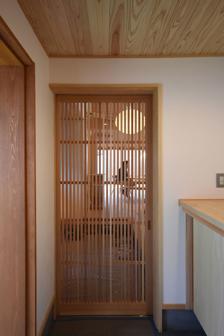 an open wooden door in a white room