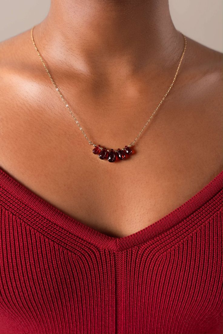 The Elodie necklace reflects your innate elegance, this delicate gold-filled necklace is handcrafted with 5 Mozambique garnet drops will make your outfit standout with their deep red hues. Packaged in an elegant plastic-free reusable jewelry box, they make the perfect gift or special treat for oneself.  14k gold-filled chain in 3 size options (40cm/45cm/50cm) Natural Mozambique garnet stones Hypoallergenic, suitable for even the most sensitive skin Delivered in a 100% silk jewelry pouchette insi Elegant 14k Gold-filled Red Jewelry, Elegant Red Gold Jewelry, Garnet Necklaces For Gifts, Red 14k Gold-filled Gemstone Jewelry, Elegant Amber Birthstone Necklace For Gift, Elegant Red Garnet Necklaces, Elegant Red Garnet Necklace, Elegant Red Necklace For Everyday, Elegant Everyday Red Necklace