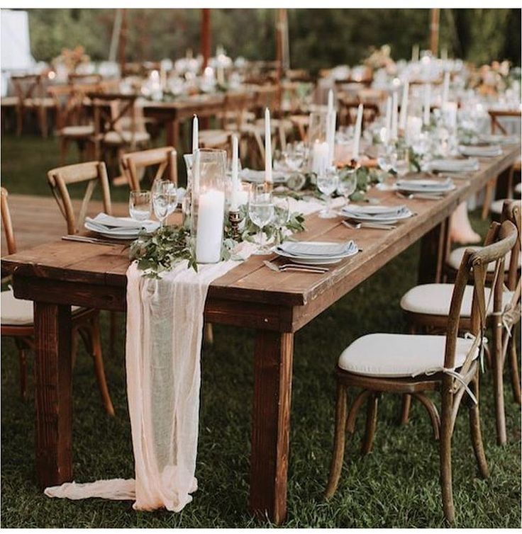 a long table set up for an outdoor wedding