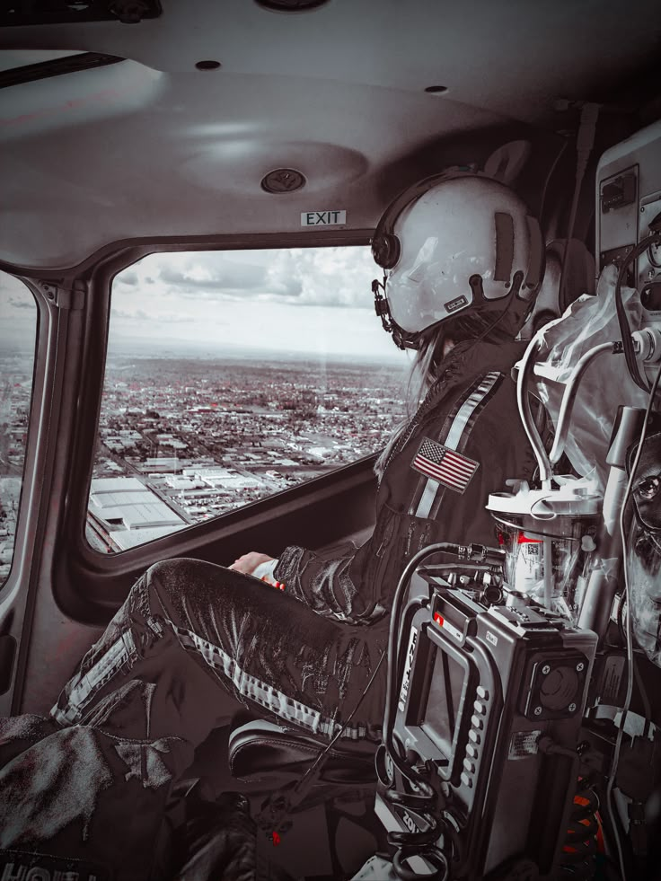 a man sitting in the cockpit of an airplane looking out over a cityscape