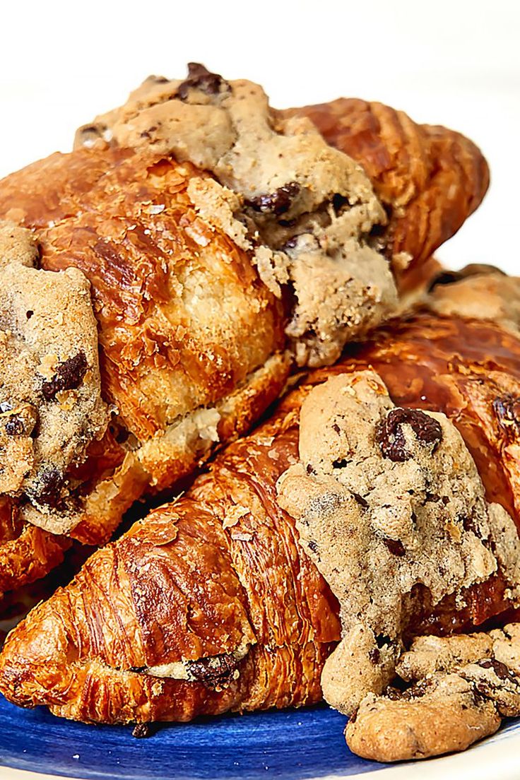 several croissants are piled on top of each other with chocolate chip toppings